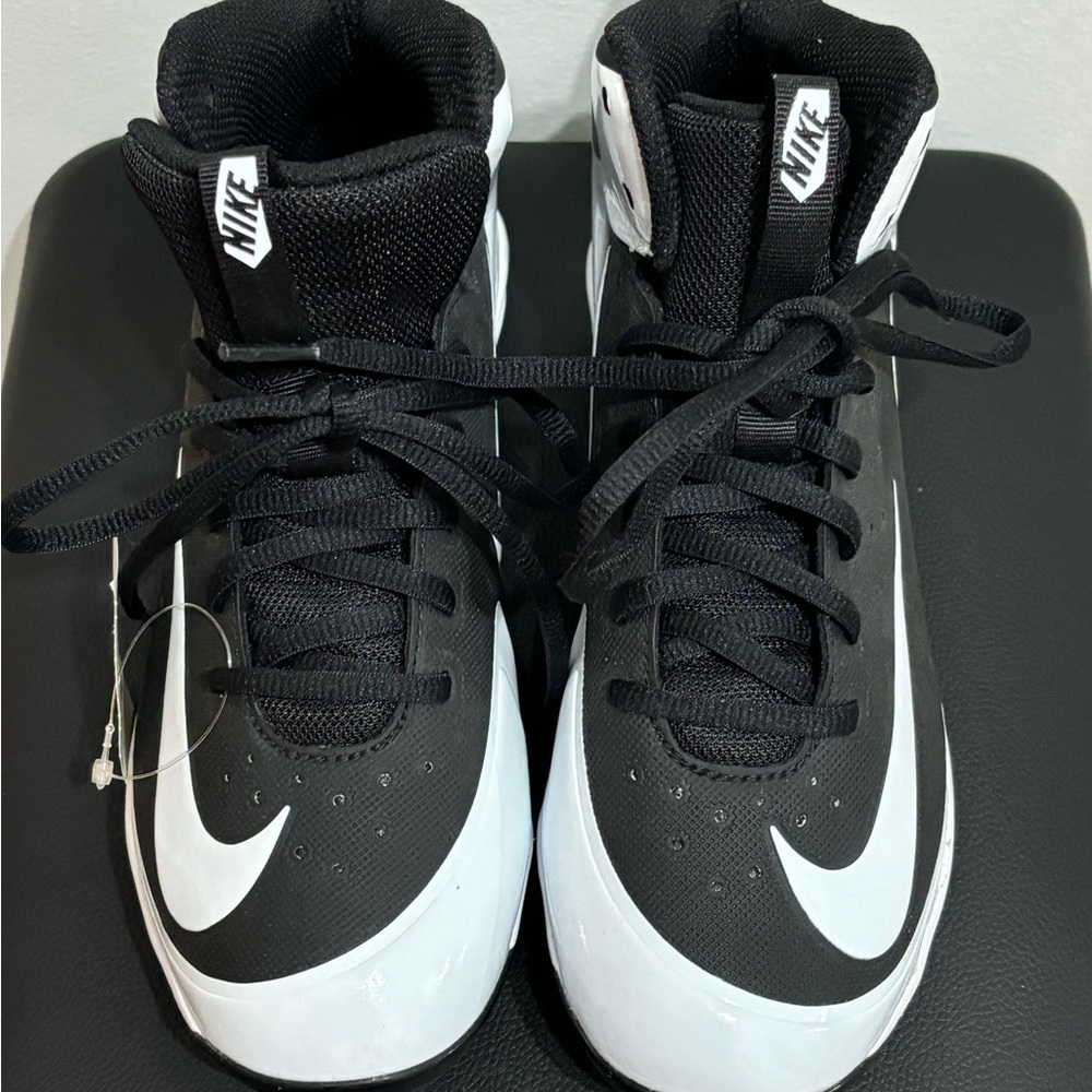 Nike Kids Black and White High-Top baseball cleats.